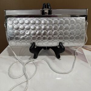 NWOT Kate Landry silver clutch with circles.  Large "diamond" clasp,